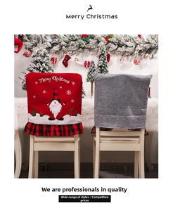 Detail of Merry Christmas chair covers with festive red plaid trim and gnome embroidery