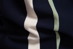 Macro shot of navy blue knit polo shirt fabric with beige and green vertical stripes
