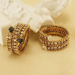 Detail of 18k gold plated chain rings with heart-shaped black and clear crystals