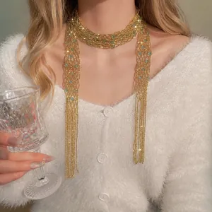 Elegant gold crystal beaded tassel necklace shown on model with fuzzy sweater