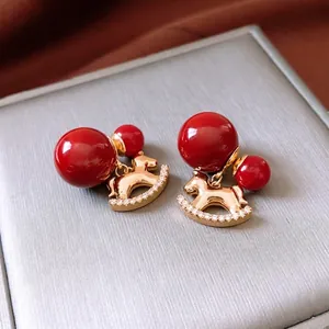Exquisite 18K gold-plated red rocking horse earrings with pearls and zircon stones