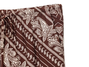 Detailed macro shot of paisley print drawstring waist on dark brown leisure trousers