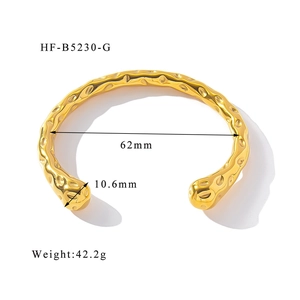 Detailed view of irregular hammered texture on 18k gold-plated cuff with dimensions