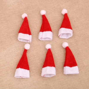 Set of 6 mini red and white felt Christmas lollipop hats with pom poms on burlap background