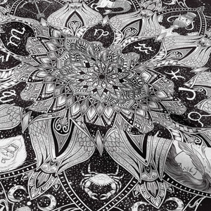 Close-up of black and white bohemian tapestry featuring zodiac symbols and mandala print