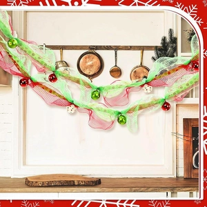 Detail of red and green Christmas mesh ribbon with ball ornaments hanging in kitchen decor