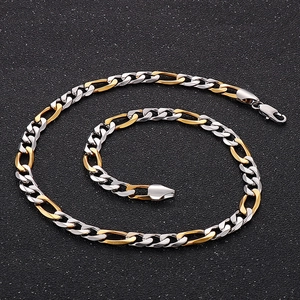 Close-up of two-tone silver and gold Figaro chain necklace with a lobster clasp