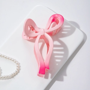 Detail of pink gradient ribbon hair claw clip with matte finish and pearl accents
