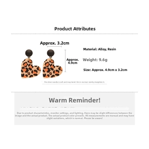 Detailed view of leopard print resin heart earrings with 4.9cm by 3.2cm dimensions