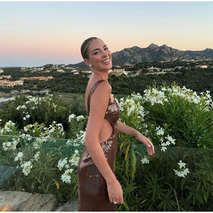 Side view of a sexy brown sequin cutout party dress worn by a model in nature
