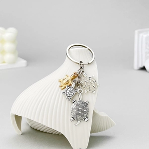 Antique silver and gold turtle alloy keychain featuring hollow embossed turtle charms