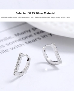 Macro shot of S925 sterling silver D-shaped earrings with sparkling cubic zirconia inlay