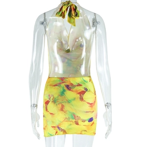 Back view of colorful abstract print halter dress with slim fit on mannequin