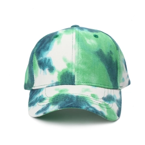 Close-up of green and white tie-dye baseball cap with cotton canvas texture details