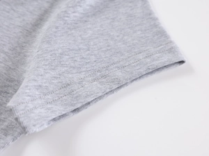 Detailed macro view of the double-stitched cuff on a grey slim-fit ribbed T-shirt
