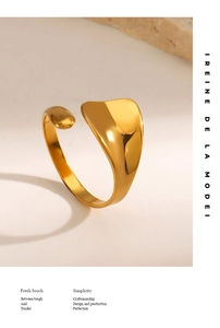 Detailed view of wide gold-plated stainless steel ring with organic streamlined design