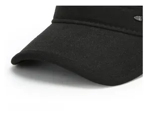 Detailed close-up of a black winter cap brim with reinforced stitching and sport metal tag