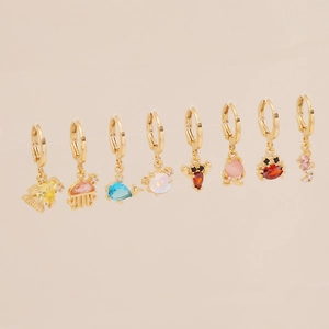 Detailed view of eight assorted gold sea animal earrings with colorful zircon stones