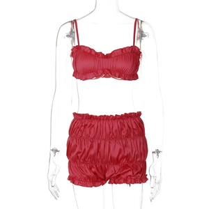 Detailed view of red satin two-piece lingerie set with ruched shorts and camisole top