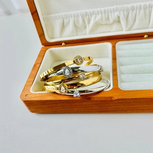 Waterproof stainless steel bangle set with teardrop zircon pendants in gold and silver finish