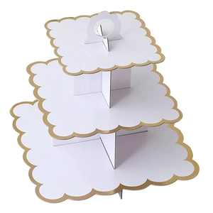 Three-tier white cardboard cupcake stand with elegant gold scalloped edges for party