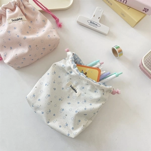 Floral drawstring pouches showing portable storage for pens and stationery items