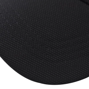 Macro view of breathable black mesh fabric with reinforced stitching on baseball cap brim
