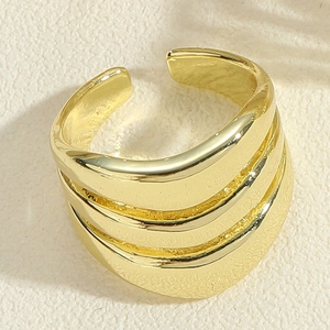 Detailed view of wide gold layered croissant ring with polished surface and open design