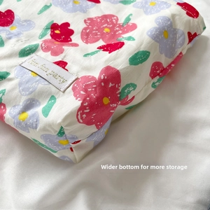 Detail view of the widened bottom structure of this floral cotton toiletry bag