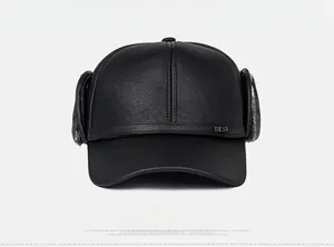 Detail of winter PU leather baseball cap with earflaps and warm thick grey plush lining