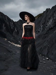 Elegant black sequin tube top evening gown with red feather waist and layered tulle skirt