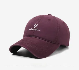 Detail view of burgundy washed cotton baseball cap with adventure embroidery