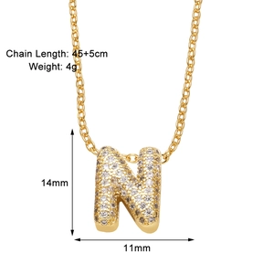 Macro shot of gold letter N necklace with zircon inlay and detailed size measurements