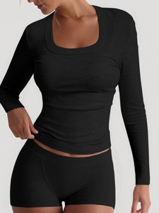 Detailed view of women's black ribbed long sleeve top and mini skirt set with round neck