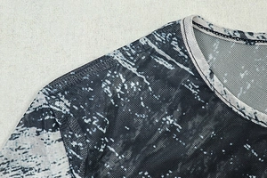 Detail of round neckline and stitching on breathable marble print mesh long sleeve dress