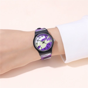 Close-up of purple camouflage quartz watch with silicone strap on a female wrist