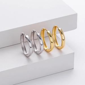 Close-up of S925 sterling silver hoop earrings in gold and silver with hallmark