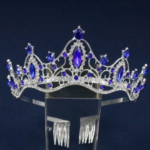 Close-up of luxury bridal crown with large blue crystals and sparkling rhinestones