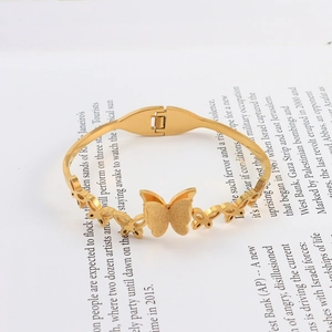 Close-up of golden butterfly bracelet with matte finish and spring hinge detail