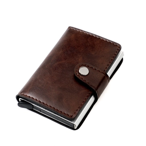 Detail view of brown textured leather RFID card holder with metallic popup mechanism