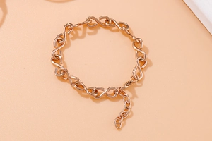 Detailed view of rose gold S-shaped infinity link chain with adjustable lobster clasp