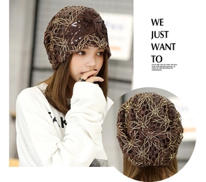 Detail of brown lace beanie featuring floral embroidery and sequins with mesh texture