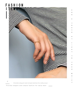 Close-up of minimalist gold chain ring worn on index finger with a casual chic outfit