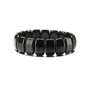 Détail de perles d'hématite noire brillante sur cordon élastique avec formes rectangulaires