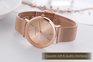Macro detail of rose gold ladies' watch featuring a minimalist dial and metal mesh strap