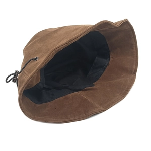 Detail of adjustable drawstring and metal buckle inside the brown suede bucket hat