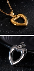 Detail of hollow heart-shaped pendants in polished gold and silver finishes