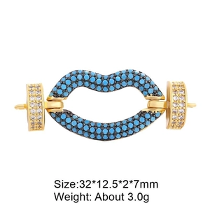 Detailed macro of gold lip-shaped jewelry connector with blue stones and white zircons
