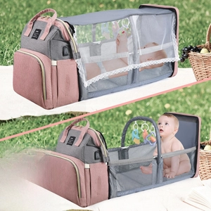 Detail of portable diaper bag unfolding into a crib with sunshade and USB port