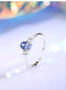 Macro shot of adjustable S925 silver ring with oval blue gemstone and cubic zirconia
